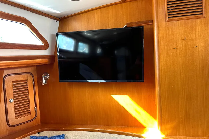 Slide: The Image of Flat-screen TV mounted on wooden interior of 2006 Passport 470 yacht. - 9