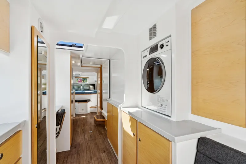 Slide: The Image of Modern interior of 2024 St Francis 460 yacht with washer, wood accents, and cozy seating. - 100