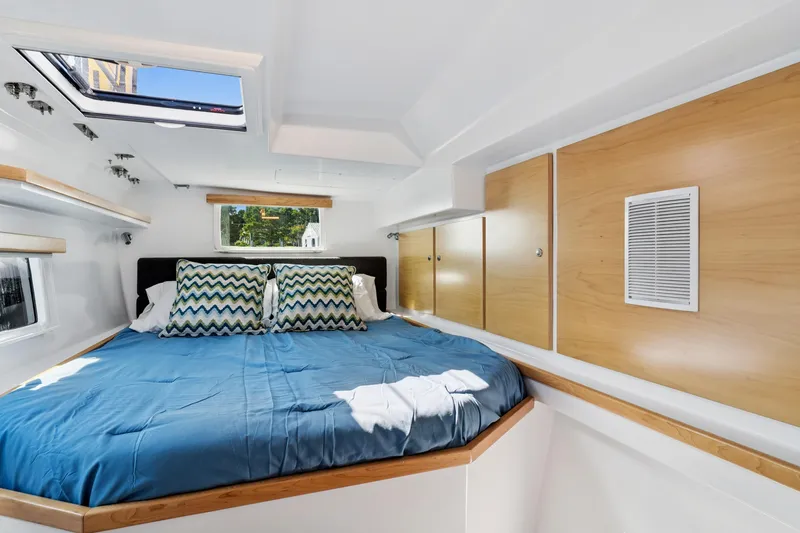Slide: The Image of 2024 St Francis 460 yacht interior with cozy bed, skylight, and wooden cabinets. - 103