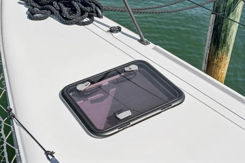 Slide: The Image of Hatch on 2024 St Francis 460 yacht deck, with coiled rope and water view. - 120
