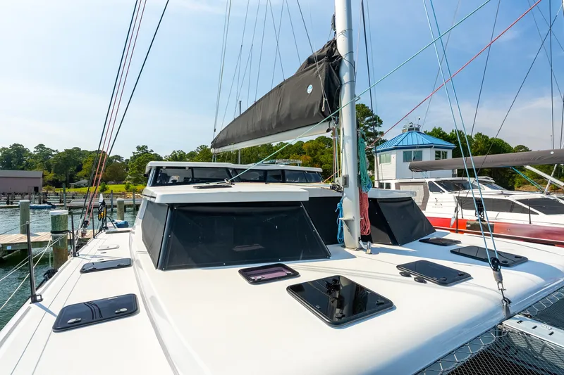 Slide: The Image of 2024 St Francis 460 catamaran docked at marina, showcasing sleek design and modern features. - 13