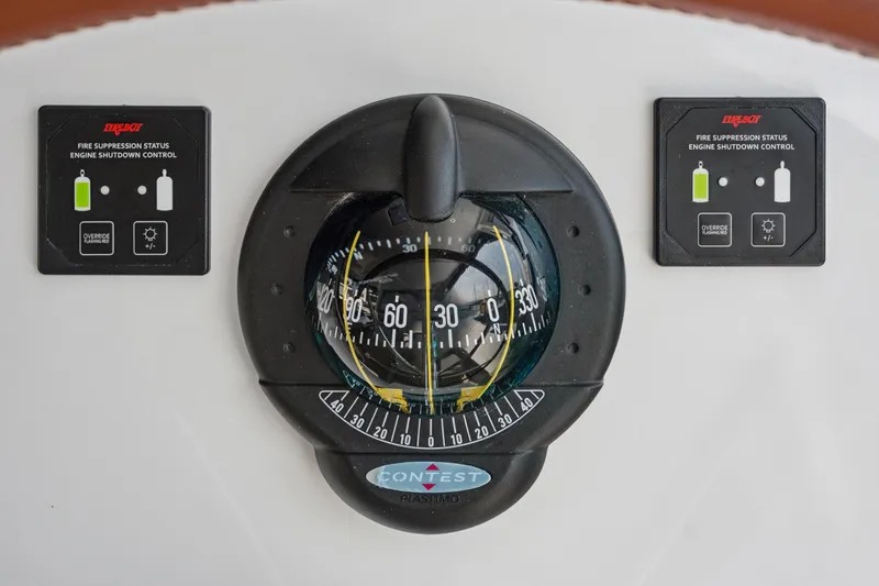 Slide: The Image of Compass and fire suppression controls on 2024 St Francis 460 yacht dashboard. - 141