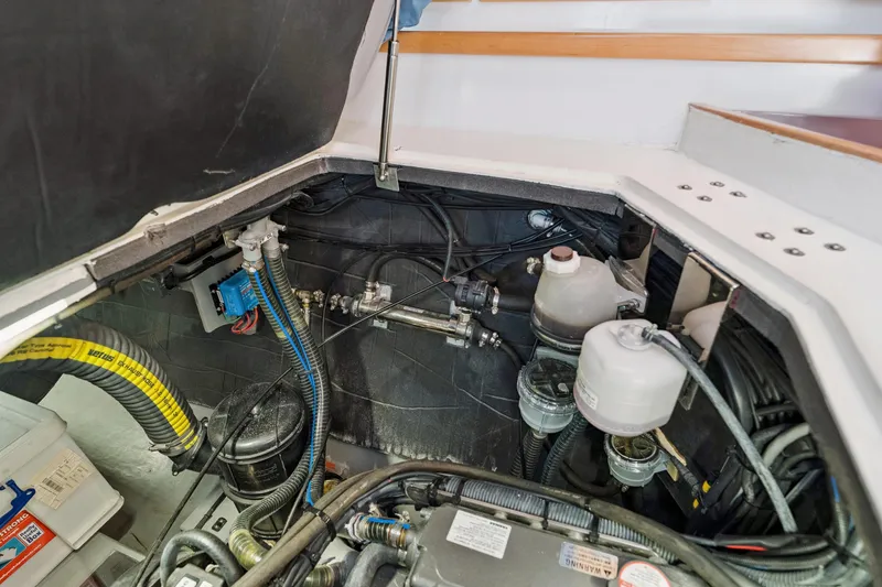 Slide: The Image of Engine compartment of 2024 St Francis 460 boat, showcasing mechanical components and wiring. - 153