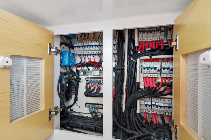 Slide: The Image of Electrical panel inside 2024 St Francis 460, showcasing organized wiring and circuit breakers. - 155