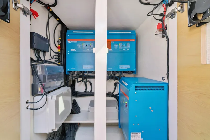 Slide: The Image of Electrical system setup in 2024 St Francis 460 model, featuring blue inverters and wiring. - 157