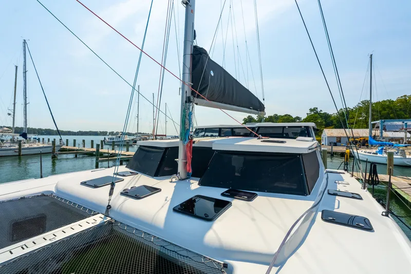 Slide: The Image of 2024 St Francis 460 catamaran docked at a marina, showcasing sleek design and modern features. - 16