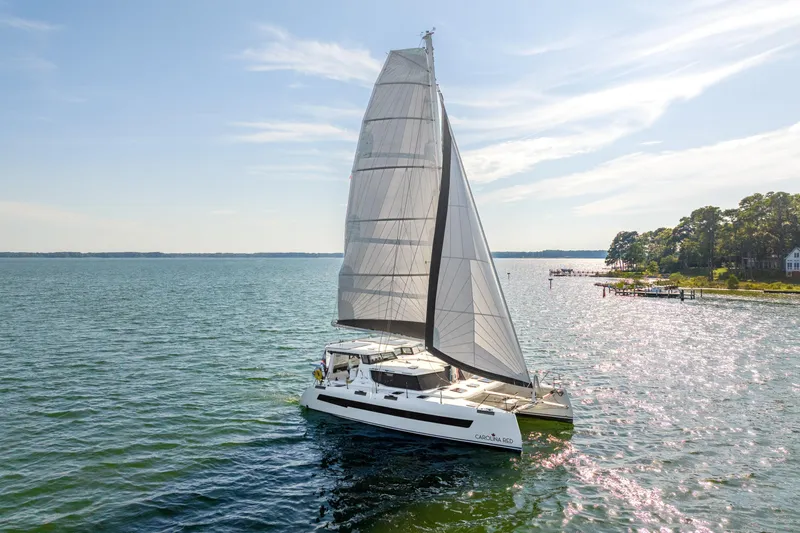 Slide: The Image of 2024 St Francis 460 catamaran sailing on a sunny day near the coastline. - 168