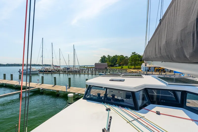 Slide: The Image of 2024 St Francis 460 yacht docked at a marina with sailboats and clear skies. - 19