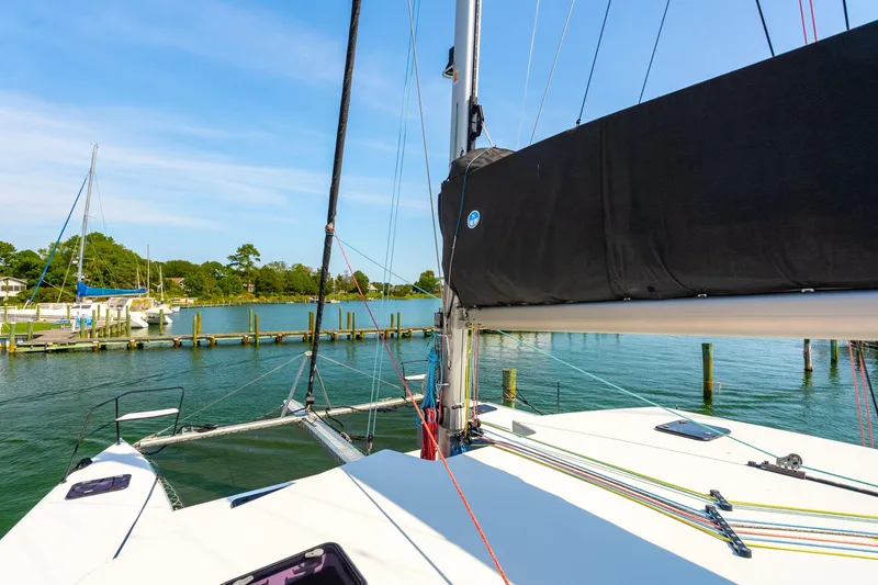 Slide: The Image of 2024 St Francis 460 catamaran docked in a serene marina setting. - 21