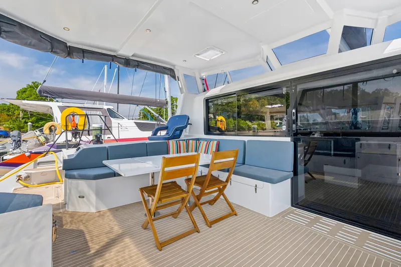 Slide: The Image of 2024 St Francis 460 yacht interior with seating, table, and sliding glass doors. - 30