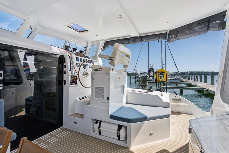 Slide: The Image of 2024 St Francis 460 yacht cockpit with modern helm and marina view. - 33
