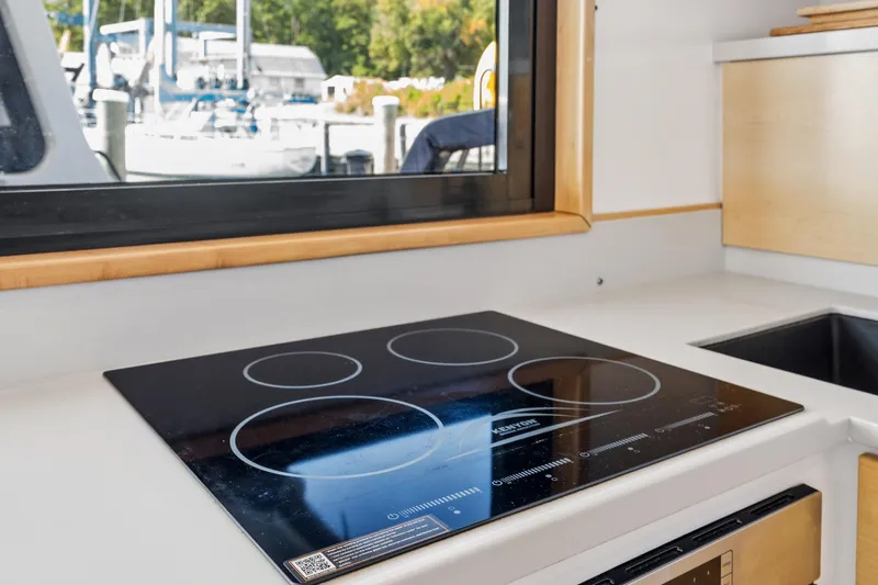 Slide: The Image of Modern kitchen in 2024 St Francis 460 yacht with induction cooktop and window view. - 57