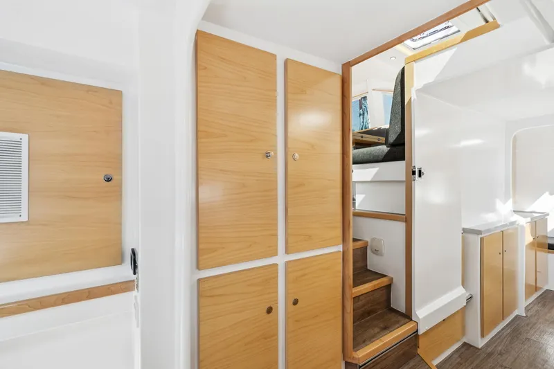 Slide: The Image of 2024 St Francis 460 interior with wooden cabinets and stairs, showcasing modern yacht design. - 61