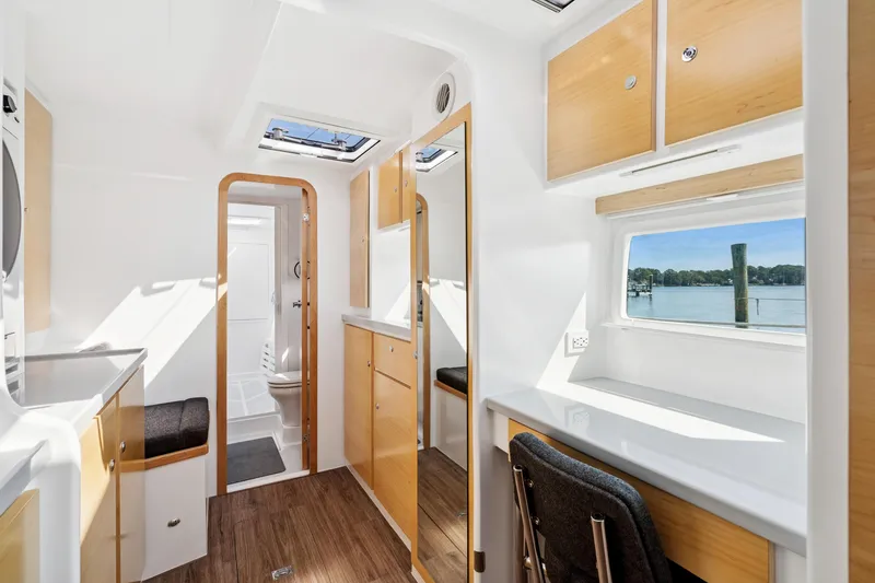 Slide: The Image of 2024 St Francis 460 yacht interior with modern design, featuring wood accents and scenic window view. - 65