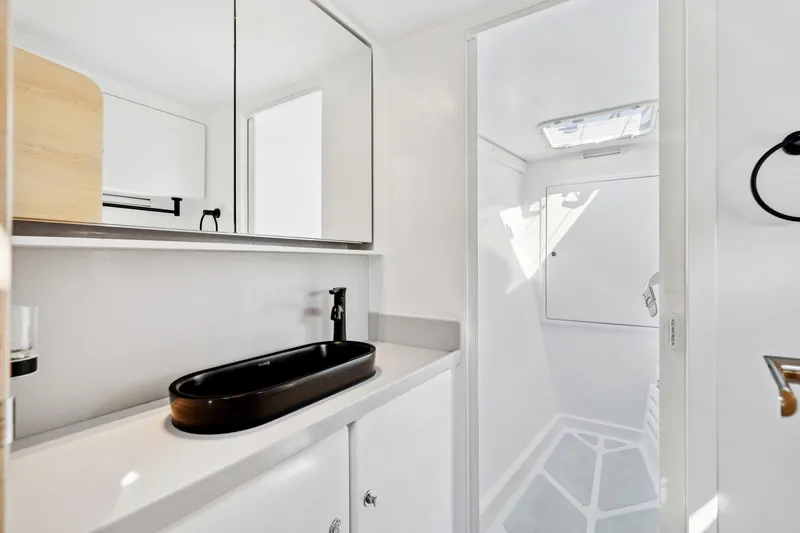 Slide: The Image of Modern bathroom in 2024 St Francis 460 yacht with sleek black sink and mirrored cabinet. - 66