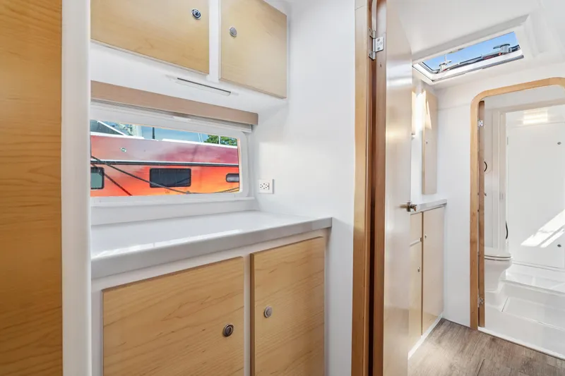 Slide: The Image of Modern interior of 2024 St Francis 460 yacht with wood cabinets and bright lighting. - 69