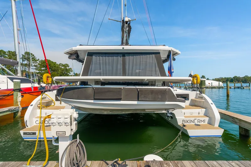 Slide: The Image of 2024 St Francis 460 catamaran docked at marina, rear view with clear sky. - 7