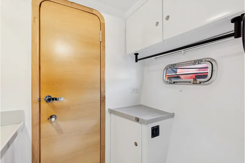 Slide: The Image of 2024 St Francis 460 interior with wooden door, white cabinets, and small window. - 80