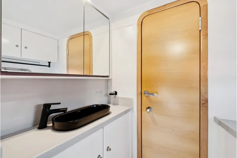 Slide: The Image of Modern bathroom in 2024 St Francis 460 yacht with sleek black sink and wooden door. - 81