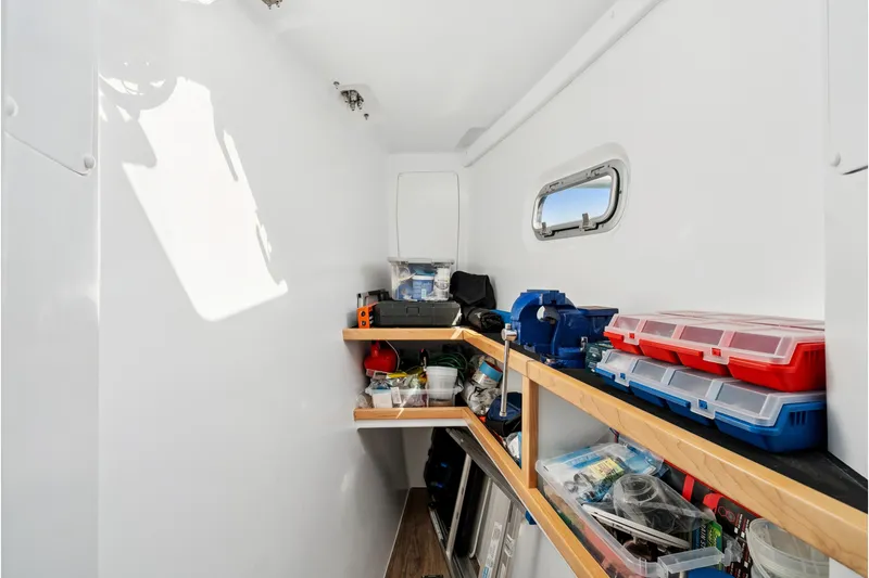 Slide: The Image of Interior of 2024 St Francis 460 boat with organized storage shelves and tools. - 82