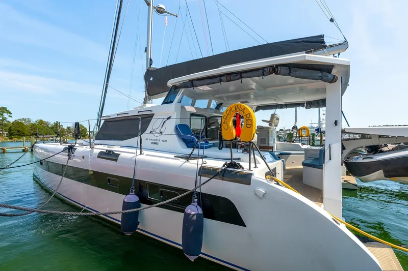 Slide: The Image of 2024 St Francis 460 catamaran docked in a marina, featuring sleek design and modern amenities. - 9