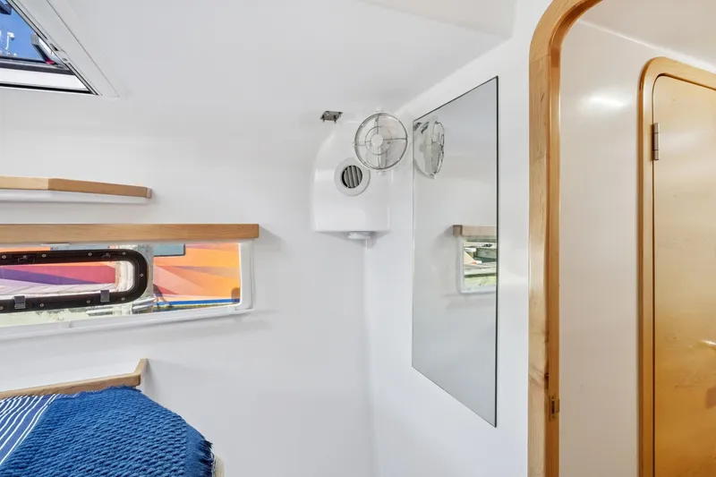 Slide: The Image of Interior of 2024 St Francis 460 yacht cabin with window and fan. - 93