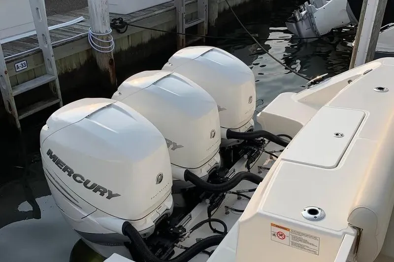 Slide: The Image of Triple Mercury outboard engines on a 2019 Boston Whaler 380 Outrage at dock. - 10