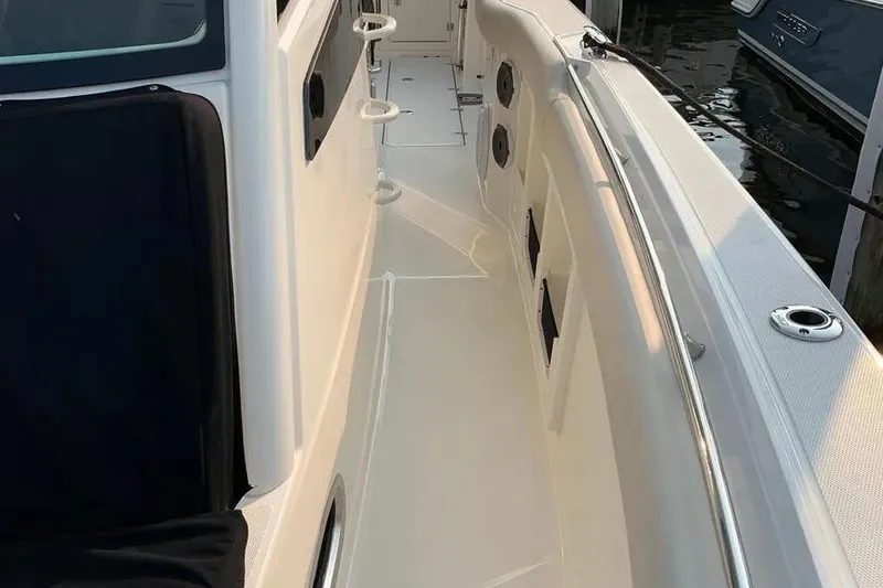 Slide: The Image of 2019 Boston Whaler 380 Outrage boat deck with sleek design and cup holders. - 13