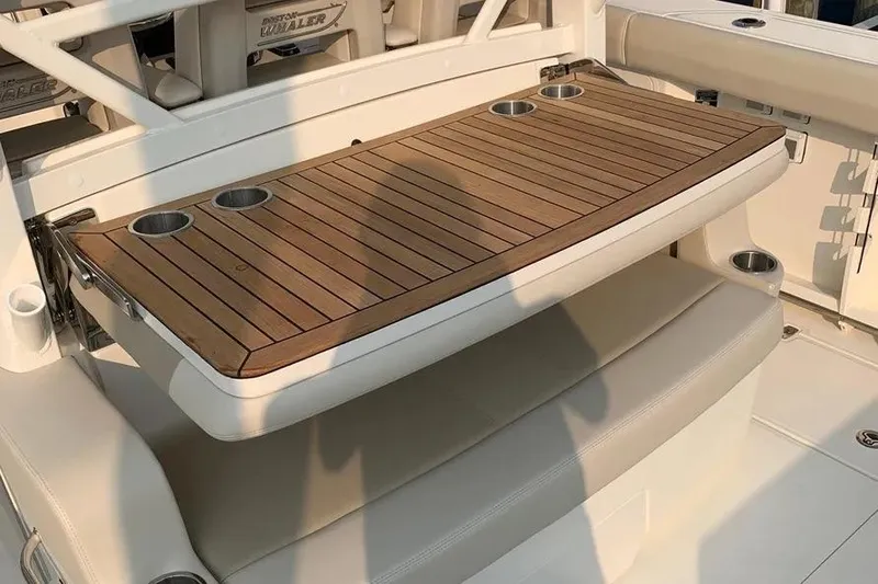 Slide: The Image of 2019 Boston Whaler 380 Outrage boat with wooden table and cup holders. - 16
