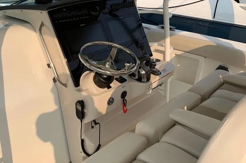 Slide: The Image of 2019 Boston Whaler 380 Outrage helm with steering wheel and controls. - 17