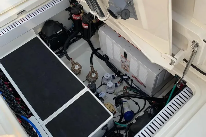 Slide: The Image of 2019 Boston Whaler 380 Outrage engine compartment with mechanical components and wiring. - 24