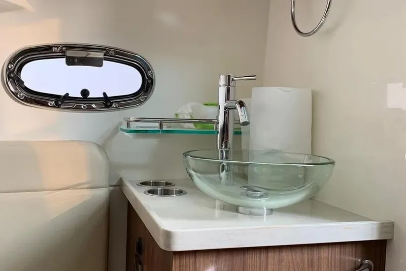Slide: The Image of Luxurious bathroom interior of 2019 Boston Whaler 380 Outrage with glass sink and porthole. - 27