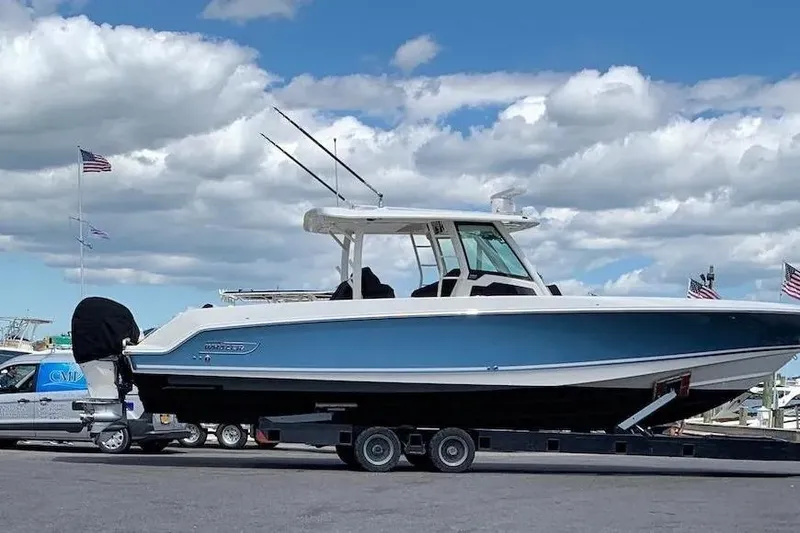 Slide: The Image of 2019 Boston Whaler 380 Outrage boat on trailer under cloudy sky. - 3