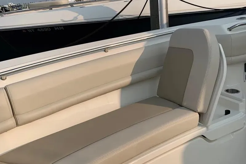 Slide: The Image of 2019 Boston Whaler 380 Outrage boat seating area with beige upholstery. - 38