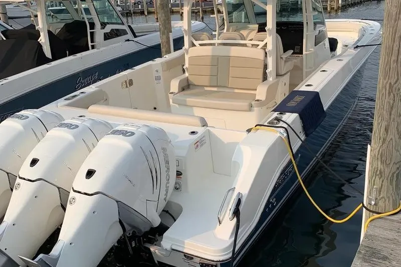 Slide: The Image of 2019 Boston Whaler 380 Outrage boat docked with triple Mercury engines. - 41
