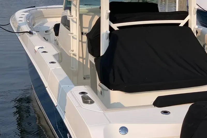 Slide: The Image of 2019 Boston Whaler 380 Outrage boat docked, featuring sleek design and covered seating. - 42