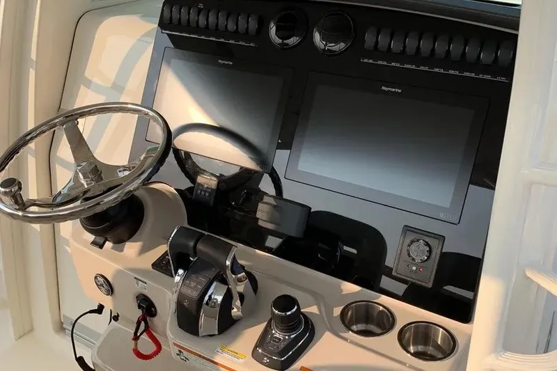 Slide: The Image of Control panel of a 2019 Boston Whaler 380 Outrage with dual screens and steering wheel. - 46