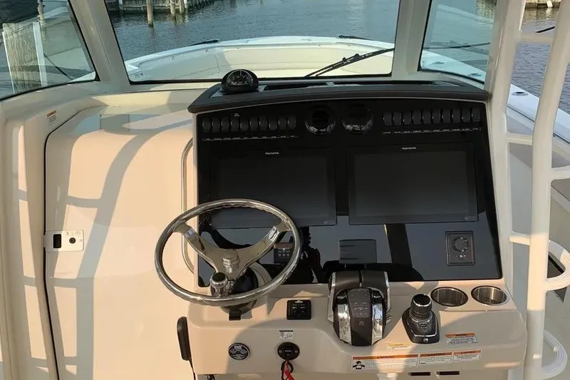 Slide: The Image of 2019 Boston Whaler 380 Outrage helm with dual screens and steering wheel. - 47