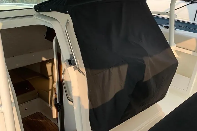 Slide: The Image of 2019 Boston Whaler 380 Outrage cabin entrance with black cover. - 49