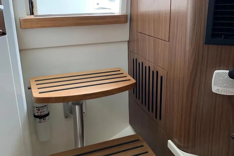 Slide: The Image of Interior of 2019 Boston Whaler 380 Outrage, featuring wooden steps and modern design elements. - 51