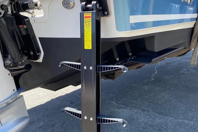 Slide: The Image of 2019 Boston Whaler 380 Outrage boat with ladder detail, docked on pavement. - 6