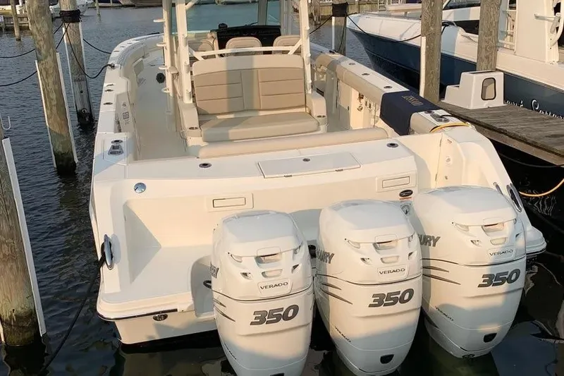 Slide: The Image of 2019 Boston Whaler 380 Outrage with triple Mercury 350 engines docked at marina. - 8
