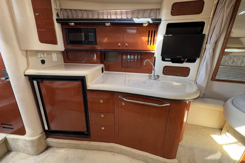 Slide: The Image of Interior of 2002 Sea Ray 340 Sundancer with kitchenette, microwave, and TV. - 21