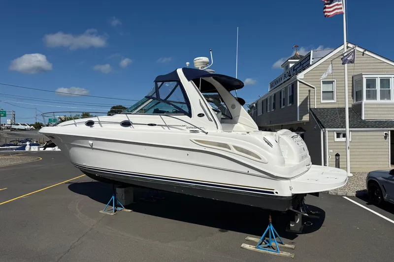 Slide: The Image of 2002 Sea Ray 340 Sundancer boat on stands outside a marina building. - 9