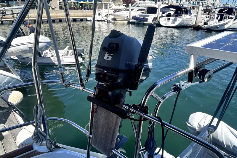 Slide: The Image of 2003 Beneteau Oceanis Clipper 473 with outboard motor in marina setting. - 10