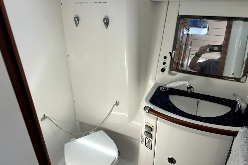Slide: The Image of Bathroom interior of 2003 Beneteau Oceanis Clipper 473 yacht, featuring toilet and sink. - 16
