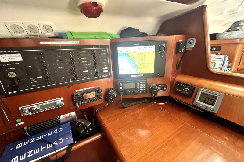 Slide: The Image of Navigation station of 2003 Beneteau Oceanis Clipper 473 with control panels and electronic displays. - 18
