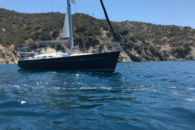 Slide: The Image of Sailboat Beneteau Oceanis Clipper 473, 2003, anchored near rocky coastline. - 7