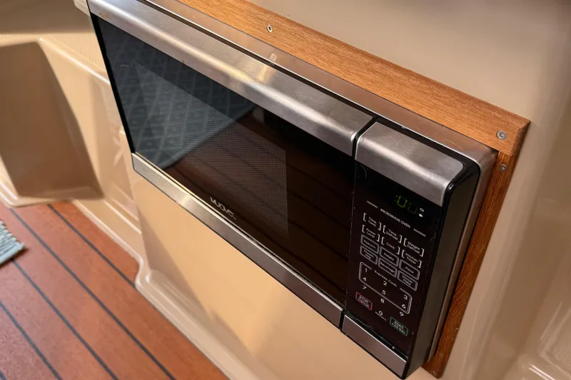 Slide: The Image of Microwave oven in 2017 Ranger Tugs R-23 boat interior with wood paneling. - 16