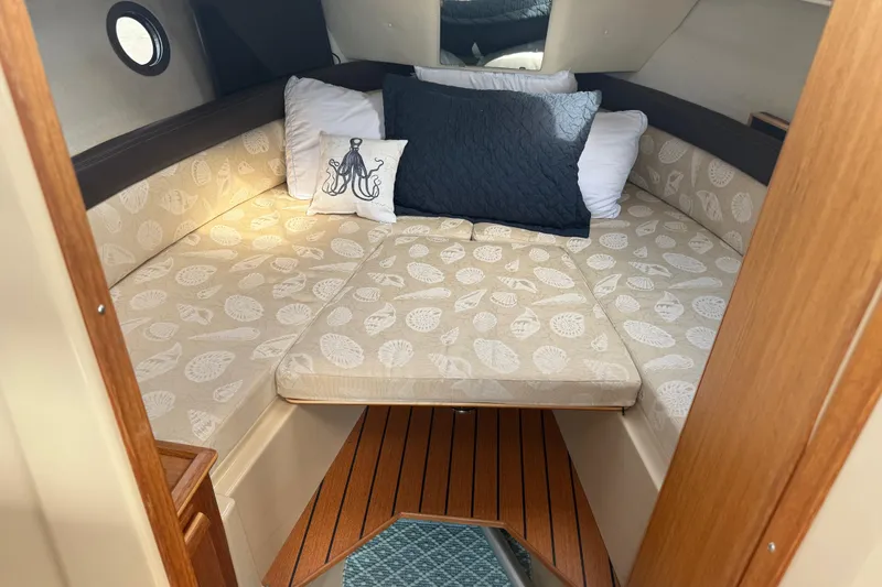 Slide: The Image of 2017 Ranger Tugs R-23 cabin interior with patterned cushions and decorative pillows. - 18